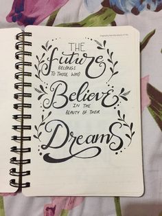 a spiral notebook with the words, the future belongs to those who believe in the energy of their dreams