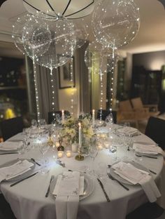 the table is set with silverware and white linens for an elegant wedding reception