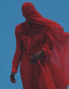 a woman in a red dress is walking