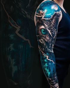 a man with a full sleeve tattoo on his arm