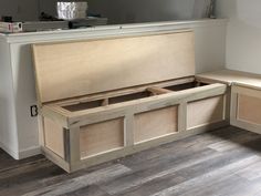 a wooden bench sitting on top of a hard wood floor next to a countertop