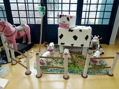 some fake farm animals are on display in a room