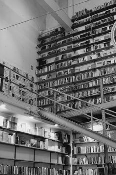 black and white photograph of bookshelves in a library