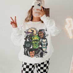 This Halloween Monster Shirt has a Vintage Halloween vibe and a fun Monster Mash themed graphic. Celebrate Spooky Season with a cute Fall sweatshirt that you will want to wear on repeat. This is a relaxed fit unisex sweatshirt, but true to size. We recommend sizing up if you want a trendy oversized look. - M A T E R I A L S - Gildan® Sweatshirt 8 oz./yd² (US) 50/50 cotton/polyester Heather Sport colors: 60/40 polyester/cotton Loose Fit Ribbed Knit Collar to retain shape - C A R E  I N S T R U C Themed Long Sleeve Tops With Cartoon Print, Themed Long Sleeve Top With Cartoon Print, Themed Long Sleeve Sweatshirt With Character Print, Themed Long Sleeve Tops With Graphic Print, Themed Long Sleeve Fan Merchandise Tops, Halloween Themed Streetwear Tops, Themed Crew Neck Top For Costume Party, Pop Culture Tops With Character Print For Fall, Halloween Pop Culture Tops With Character Print