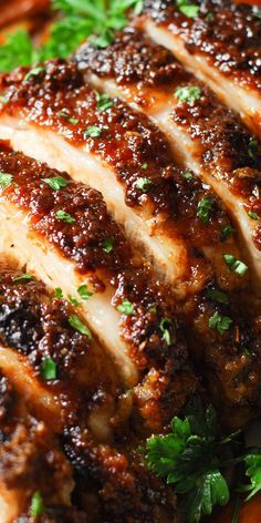 closeup of sliced meat with parsley on top and seasoning around the edges