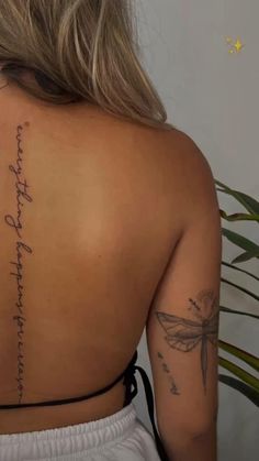 the back of a woman's shoulder with writing on it and a dragonfly