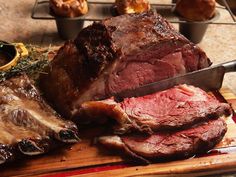 a large piece of meat sitting on top of a wooden cutting board