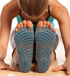 a woman is sitting on the floor with her feet up