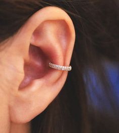 a woman's ear is shown with a thin band