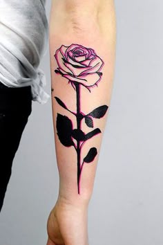 a woman with a rose tattoo on her arm