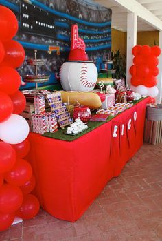 a baseball themed birthday party with balloons and desserts