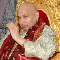 a bald man sitting in a red chair