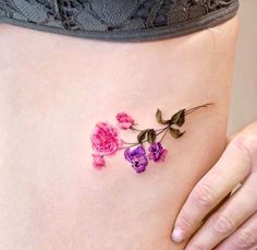 a woman's stomach with pink and purple flowers on it