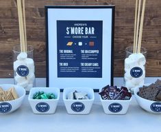 a table topped with bowls filled with different types of snacks and marshmallows