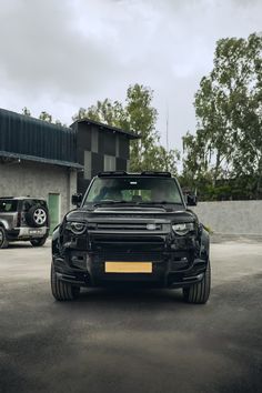 a black truck parked in front of a building