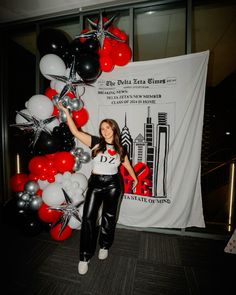 a woman standing next to a bunch of balloons