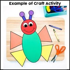 an insect craft with scissors, markers and crayons on a wooden board that says example of craft activity