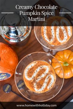 two desserts are sitting on a wooden tray with silverware and an orange pumpkin