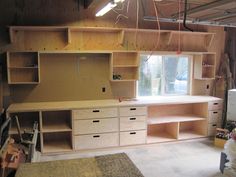 an unfinished room with shelves and drawers in it