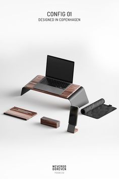 a laptop computer sitting on top of a wooden table next to other items and accessories