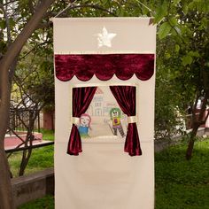 a red and white curtain with pictures on it