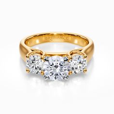 three stone engagement ring in yellow gold