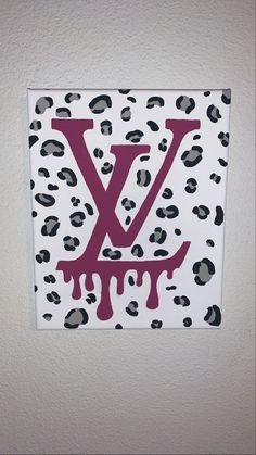 the letter y is painted on a white wall with black and pink leopard print paint