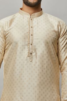 Raw Silk Kurta with gold foil print & placket plus gold churidar Crafted with a collar neckline, full sleeves, and front button closure. Occasion: Can be worn to lighter events like Sangeet, Mehendi, Puja, or a small party WASH CARE INSTRUCTIONS - Please Dry clean only when it is applicable. Slight color variation is possible due to digital photography. Cream Kurta Pajama Men, Gold Kurta For Men, Raw Silk Kurta, Shimmer Background, Mens Kurta Pajama, Indian Wedding Clothes For Men, Kurta Pajama Men, Gents Kurta, Kurta Men