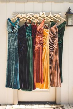 there are many dresses hanging on the clothes rack