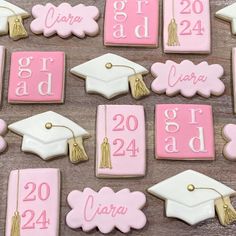 graduation cookies decorated with pink and white icing