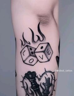 a tattoo with two dices on it and flames coming out of the top one