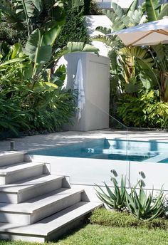 an outdoor swimming pool with steps leading up to it