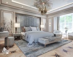 a large bed sitting in the middle of a bedroom next to two chairs and a chandelier