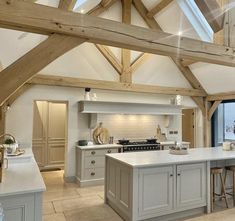 a large kitchen with an island in the middle and lots of counter space on one side