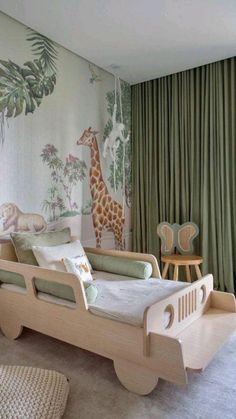 a child's bedroom with green curtains and giraffes on the wall