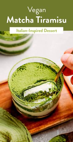 a person is dipping something into a green drink