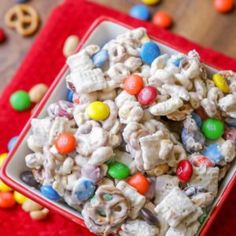 a red bowl filled with cereal and candy