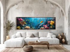 a living room with a large painting on the wall and a white couch in front of it