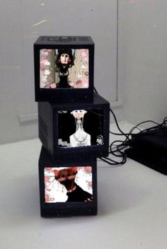 three black cubes with pictures on them