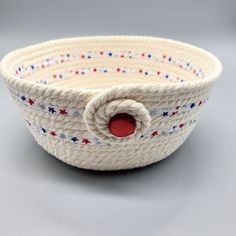 a small white basket with red, white and blue stars on it's side