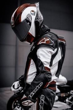 a man wearing a white and brown motorcycle suit