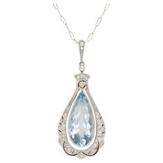 Finley crafted in 14k white gold with a Pear-Shaped Aquamarine weighing approximately 7.00 carats. The pendant features diamonds weighing approximately a total of 0.40 carats. Edwardian, circa 1910s Formal Pear-shaped Diamond Necklace, Fine Jewelry Platinum Pear-shaped Diamond Necklace, Exquisite Pear-shaped Diamond Necklace For Formal Events, Exquisite Pear-shaped Diamond Necklace For Formal Occasions, Platinum Pear-shaped Diamond Necklace, Timeless Pear-shaped White Gold Diamond Necklace, Exquisite Pear-shaped Diamond Necklace, Formal Teardrop Diamond Necklace With Gemstone, Elegant Pear-shaped Gemstone Diamond Necklace