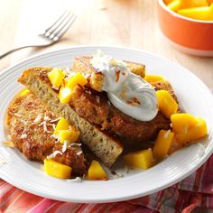 a white plate topped with french toast and fruit