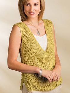 a woman wearing a yellow knitted vest with the words indlus written on it