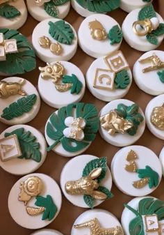 many green and gold decorated buttons are on display in a box with other decorative items