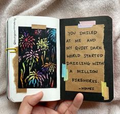 someone is holding an open book with fireworks in the background and writing on it that says, you smiled at me and my quiet dark world started dazzling with a million fireworks