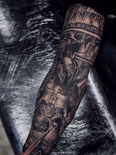 a man with a black and grey tattoo on his arm is holding a clock tower