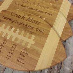 two personalized cutting boards with the names of each team and number on one board