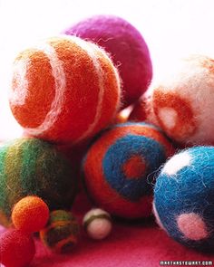 there are many different colored balls on top of each other