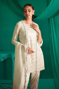 Ivory kurta with all over sequin, thread embroidery. Paired with a draped dhoti pant and peach dupatta. - Aza Fashions Off White Mirror Work Set For Eid, Off White Eid Set With Mirror Work, White Churidar With Mirror Work For Reception, Festive Off White Sets For Diwali, Festive Off-white Sets For Diwali, Peach Dupatta, Tulip Pants, Dhoti Pants, Thread Embroidery